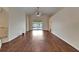Open living room with hardwood floors, sliding glass doors to the pool, and a ceiling fan at 2330 Lawrence Hall St, Ruskin, FL 33570