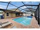 Large pool and patio featuring a screen enclosure and lounge chairs at 2330 Lawrence Hall St, Ruskin, FL 33570