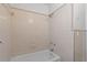 Simple bathroom features a shower-tub combo and neutral tiling at 2449 16Th N St, St Petersburg, FL 33704