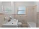 Classic bathroom with a built-in vanity, matching tilework, window, and a combination tub/shower at 2449 16Th N St, St Petersburg, FL 33704