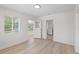 This bright bedroom features wood floors, neutral paint, and a view to the hall and kitchen at 2449 16Th N St, St Petersburg, FL 33704
