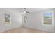 This bright, empty bedroom has many windows and gorgeous floors at 2449 16Th N St, St Petersburg, FL 33704