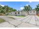 Exterior shot showcasing a beautifully maintained home with a spacious driveway and detached two-car garage at 2449 16Th N St, St Petersburg, FL 33704