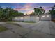 The exterior is a home with a large paved driveway and a well-manicured lawn at 2449 16Th N St, St Petersburg, FL 33704