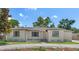 Charming single-story home with a neutral color scheme, complemented by lush landscaping and a well-manicured lawn at 2449 16Th N St, St Petersburg, FL 33704