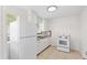 The well-lit kitchen offers essential appliances, clean white cabinets, and neutral countertops at 2449 16Th N St, St Petersburg, FL 33704