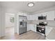 Spacious kitchen featuring stainless steel appliances, bright white cabinets, and new flooring at 2449 16Th N St, St Petersburg, FL 33704
