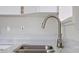 Close up of kitchen sink and faucet, paired with quartz counter tops and new cabinets at 2449 16Th N St, St Petersburg, FL 33704