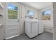 Laundry room with updated washer and dryer appliances next to the door and windows at 2449 16Th N St, St Petersburg, FL 33704