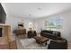 Staged living room showcasing a fireplace, window with blinds, and an archway to the dining area at 2449 16Th N St, St Petersburg, FL 33704