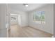 Bright, empty room has large window and gorgeous floors at 2449 16Th N St, St Petersburg, FL 33704