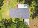 Aerial view of the roof and carport, surrounded by green landscape, offering a glimpse of the property's layout at 25623 Inkwood Pl, Wesley Chapel, FL 33544