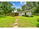 Expansive backyard with green grass and mature trees, perfect for outdoor activities at 25623 Inkwood Pl, Wesley Chapel, FL 33544