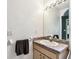 Bathroom featuring vanity with countertop and sink, mirror, and lighting at 25623 Inkwood Pl, Wesley Chapel, FL 33544