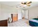 Bedroom with tile flooring, ceiling fan, closet, and a dresser at 25623 Inkwood Pl, Wesley Chapel, FL 33544