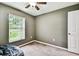 Bedroom with a ceiling fan, window, carpet flooring, and neutral-colored walls at 25623 Inkwood Pl, Wesley Chapel, FL 33544