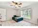 Bright bedroom with tile flooring, ceiling fan, and a large window offering ample natural light at 25623 Inkwood Pl, Wesley Chapel, FL 33544