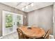 Dining area featuring a wooden table with backyard view through glass paneled french doors at 25623 Inkwood Pl, Wesley Chapel, FL 33544