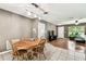 Dining area with a round wooden table and chairs near front doors and living area at 25623 Inkwood Pl, Wesley Chapel, FL 33544
