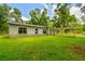 Inviting single story home with charming covered carport and lush, green lawn at 25623 Inkwood Pl, Wesley Chapel, FL 33544