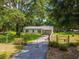 Gated property features a well-maintained home and lush green space at 25623 Inkwood Pl, Wesley Chapel, FL 33544