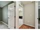 Bright hallway featuring wood and tile flooring, and inviting entrance to another room at 25623 Inkwood Pl, Wesley Chapel, FL 33544