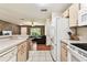 Bright kitchen with ample counter space offers an open view into the living room, perfect for Gathering interaction at 25623 Inkwood Pl, Wesley Chapel, FL 33544
