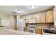 Kitchen view highlighting ample counter space, white microwave and oven, and modern sink at 25623 Inkwood Pl, Wesley Chapel, FL 33544