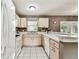 Bright kitchen with ample counter space, white appliances, and light wood cabinets offering great storage at 25623 Inkwood Pl, Wesley Chapel, FL 33544