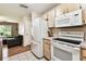 Efficient kitchen with stainless steel appliances and ample cabinet space flows into an adjacent living area at 25623 Inkwood Pl, Wesley Chapel, FL 33544
