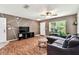 Stylish living room features a geometric accent wall, a comfortable couch, and plenty of natural light at 25623 Inkwood Pl, Wesley Chapel, FL 33544