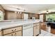 Open living area showing seamless flow from kitchen with a modern design accent wall at 25623 Inkwood Pl, Wesley Chapel, FL 33544