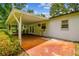 Back patio with covered seating area and view of the landscaped backyard at 25623 Inkwood Pl, Wesley Chapel, FL 33544