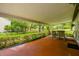 Covered patio with a table and chairs, overlooking a well-maintained yard at 25623 Inkwood Pl, Wesley Chapel, FL 33544