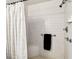 Shower with white tiled walls, shower curtain and chrome shower head at 25623 Inkwood Pl, Wesley Chapel, FL 33544
