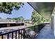 This image shows a balcony with black railings, and a community parking lot in the distance at 2932 Lichen Ln # D, Clearwater, FL 33760
