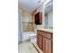 Cozy bathroom featuring a tiled tub/shower combo and granite countertop vanity at 2932 Lichen Ln # D, Clearwater, FL 33760
