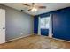 This spacious bedroom features neutral carpeting, a lighted ceiling fan, and window with bright, natural light at 2932 Lichen Ln # D, Clearwater, FL 33760