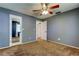 Carpeted bedroom featuring a ceiling fan, 2 closets, and natural light at 2932 Lichen Ln # D, Clearwater, FL 33760
