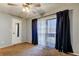 Carpeted bedroom featuring sliding glass doors, ceiling fan, and closet at 2932 Lichen Ln # D, Clearwater, FL 33760