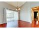 Dining area with hardwood floors, light fixture, sliding door to balcony at 2932 Lichen Ln # D, Clearwater, FL 33760