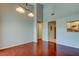 Dining room with wood floors, light fixture, pass through to kitchen and doorways to other rooms at 2932 Lichen Ln # D, Clearwater, FL 33760