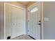 Bright entryway featuring tile floors, coat closet and a decorative glass front door at 2932 Lichen Ln # D, Clearwater, FL 33760