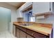 Kitchen features a stainless steel sink with wood countertops and a dishwasher, plus ample cabinet space at 2932 Lichen Ln # D, Clearwater, FL 33760