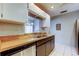 Kitchen featuring stainless steel appliances, wood countertops, and a view to the living room at 2932 Lichen Ln # D, Clearwater, FL 33760
