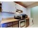 Kitchen features stainless steel appliances and light countertops, with modern microwave and stove at 2932 Lichen Ln # D, Clearwater, FL 33760