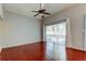 Living room with high ceilings, dark wood floors, fan and sliding doors at 2932 Lichen Ln # D, Clearwater, FL 33760