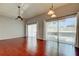 Bright living room features wood floors, ceiling fan, and sliding glass doors to let in natural light at 2932 Lichen Ln # D, Clearwater, FL 33760