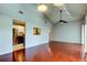 Open living area featuring wood floors, pass through to kitchen, and vaulted ceiling at 2932 Lichen Ln # D, Clearwater, FL 33760