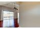 Open living area with wood floors, ceiling fan, vaulted ceilings and a sliding door to the balcony at 2932 Lichen Ln # D, Clearwater, FL 33760
